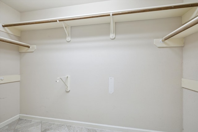 spacious closet with light tile patterned floors