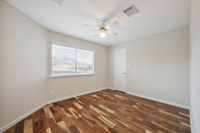 unfurnished room featuring dark hardwood / wood-style floors, ceiling fan, and a textured ceiling