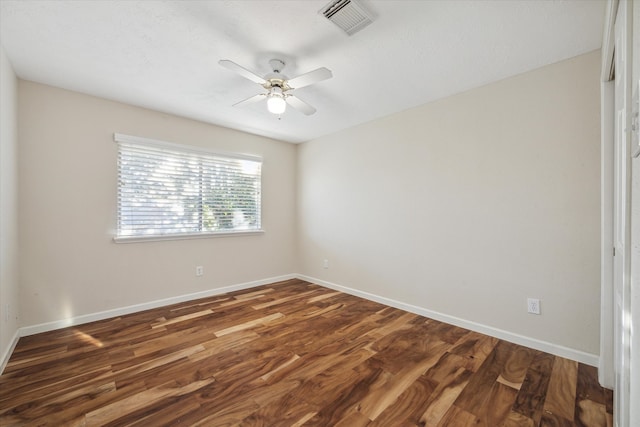 empty room with ceiling fan and dark wood-type flooring