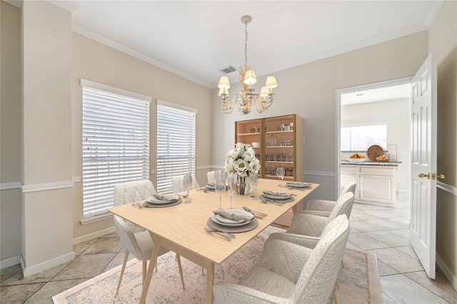 tiled dining room with a chandelier and crown molding