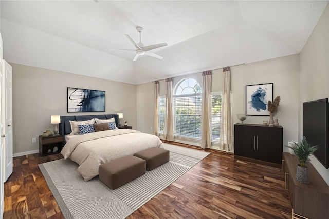 bedroom featuring ceiling fan, dark hardwood / wood-style flooring, and lofted ceiling