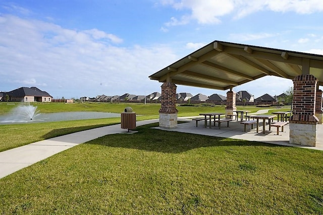 view of community featuring a yard and a water view