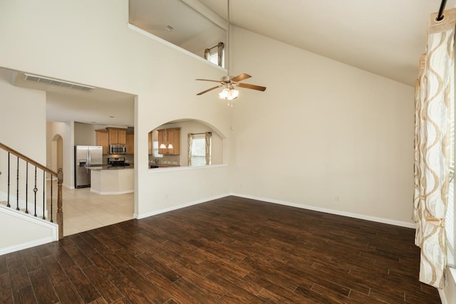 unfurnished living room featuring light hardwood / wood-style floors, high vaulted ceiling, and ceiling fan