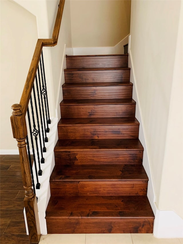 stairs featuring hardwood / wood-style flooring