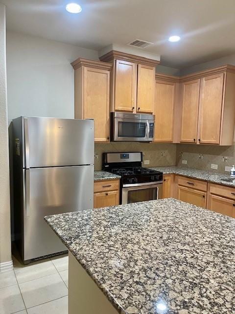 3008 Brandy Branch Ct, League City, TX 77573 - kitchen featuring decorative backsplash, visible vents, stainless steel appliances, light stone counters, and light tile patterned floors