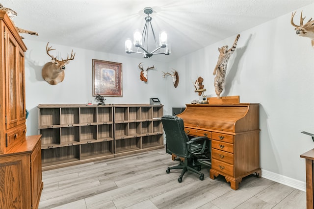 office area featuring light hardwood / wood-style floors, a textured ceiling, and an inviting chandelier