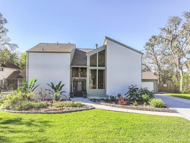 view of front of house with a garage and a front yard