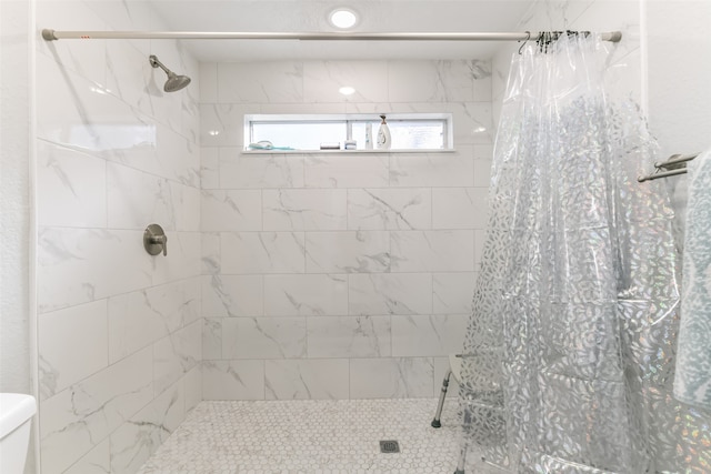 bathroom with toilet and curtained shower