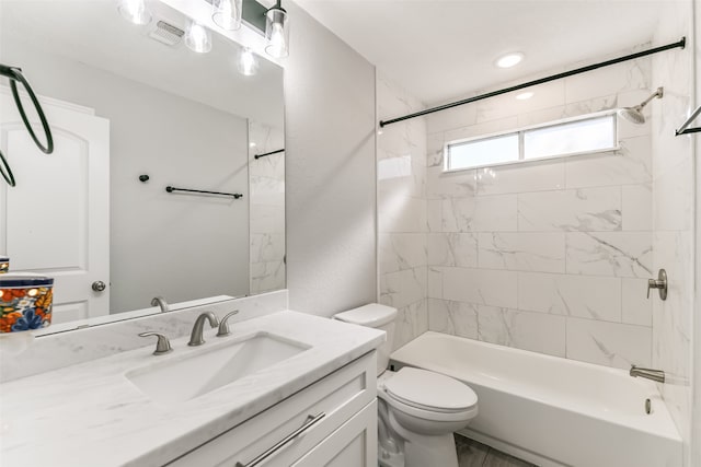 full bathroom featuring vanity, toilet, and tiled shower / bath