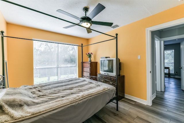 bedroom with ceiling fan and wood-type flooring