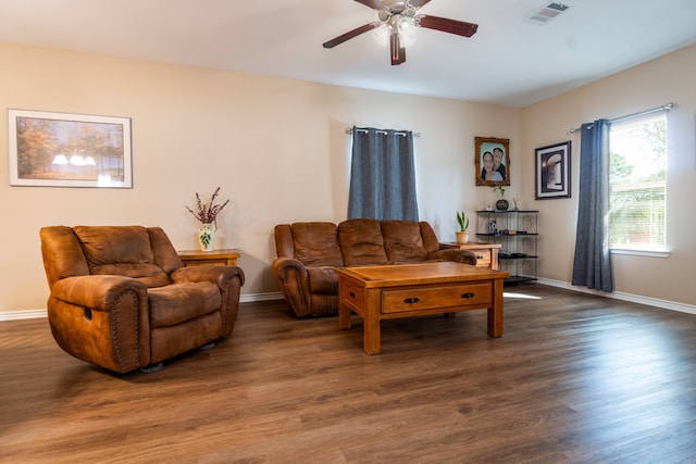 living room with dark hardwood / wood-style flooring and ceiling fan