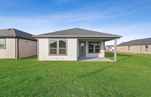 rear view of property featuring a yard and a patio