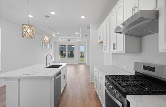 kitchen with sink, white cabinetry, an island with sink, and appliances with stainless steel finishes