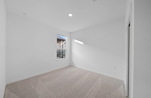 spare room with light colored carpet