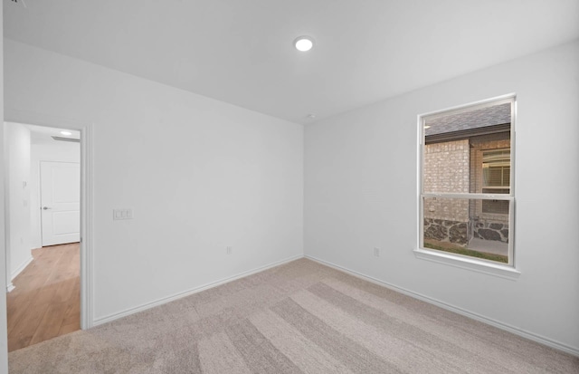 unfurnished room with light colored carpet