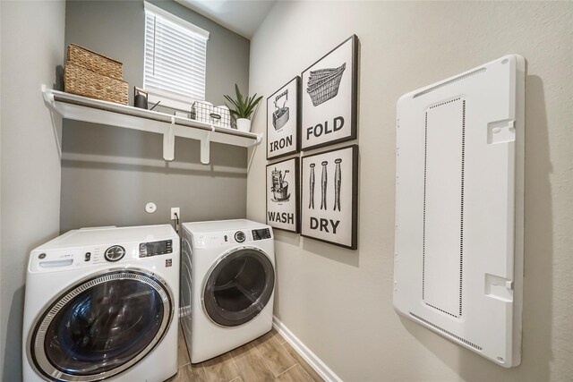 clothes washing area featuring washer and dryer