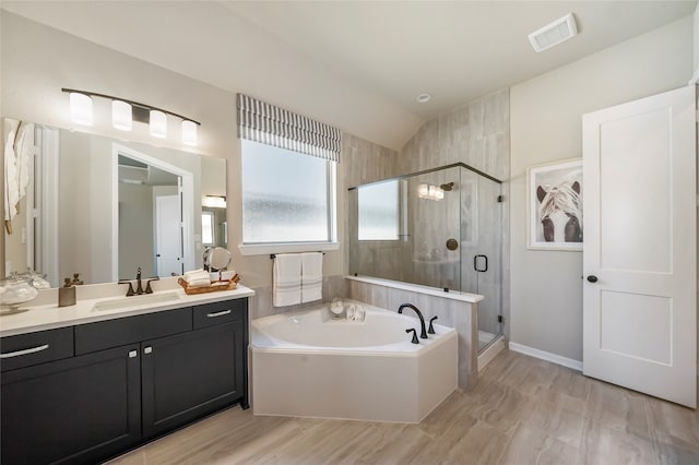 bathroom featuring shower with separate bathtub, vanity, and lofted ceiling