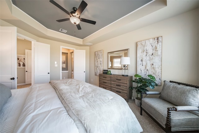 bedroom featuring a raised ceiling and ceiling fan