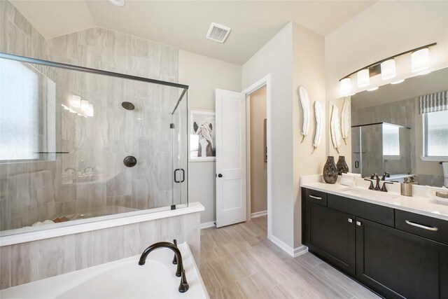 bathroom with vanity, plus walk in shower, and vaulted ceiling