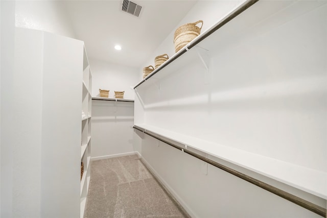 spacious closet featuring light carpet