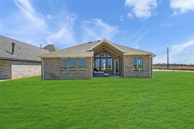 rear view of property with a lawn