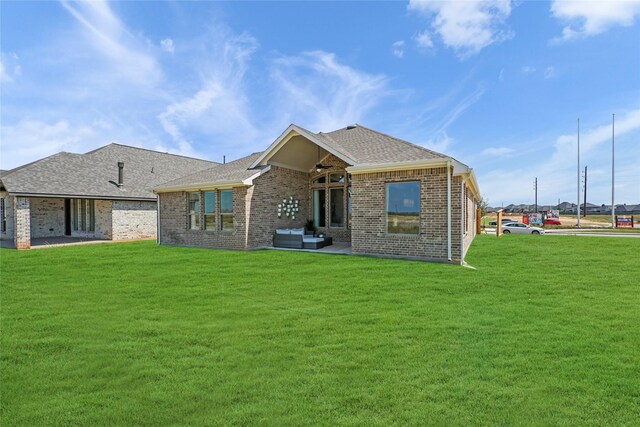 rear view of property with a lawn