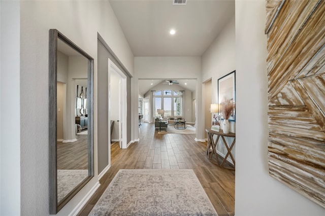 hall featuring vaulted ceiling