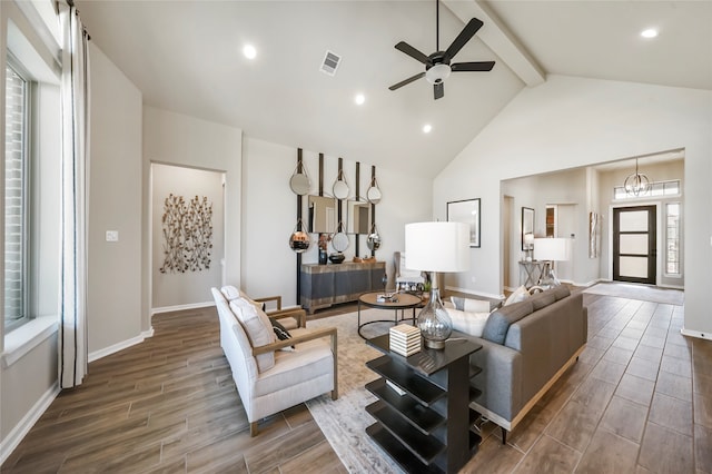 living room with ceiling fan, beam ceiling, and a wealth of natural light