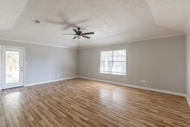 empty room featuring light wood-type flooring, crown molding, ceiling fan, and a healthy amount of sunlight