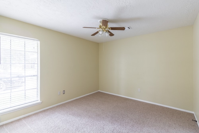 carpeted empty room with a textured ceiling and ceiling fan