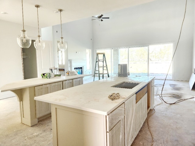 kitchen featuring pendant lighting, a center island, ceiling fan, light brown cabinetry, and a kitchen bar