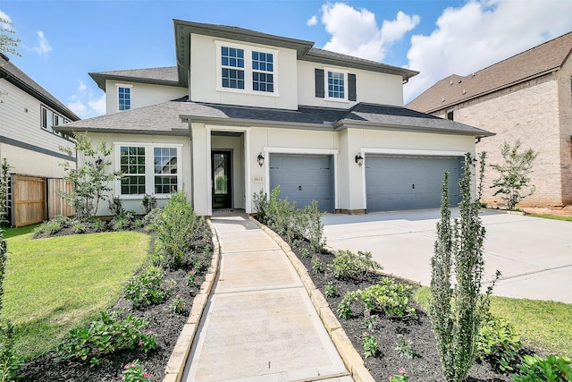 9923 Hunters Run Dr, Missouri City, TX 77459 - view of front facade featuring stucco siding, driveway, a garage, and roof with shingles