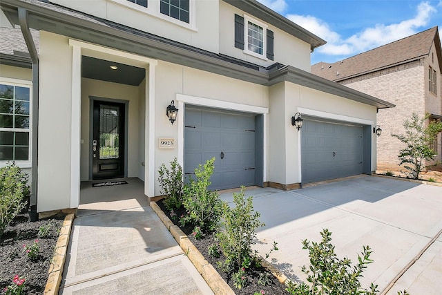 9923 Hunters Run Dr, Missouri City, TX 77459 - property entrance featuring stucco siding, driveway, and an attached garage