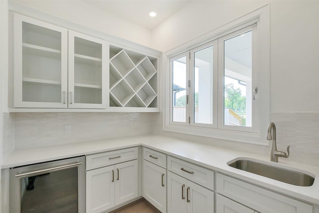 9923 Hunters Run Dr, Missouri City, TX 77459 - kitchen featuring decorative backsplash, glass insert cabinets, white cabinetry, light countertops, and recessed lighting