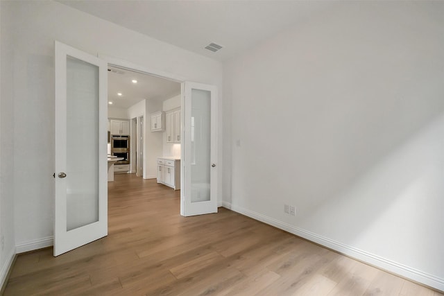 9923 Hunters Run Dr, Missouri City, TX 77459 - unfurnished bedroom featuring wood finished floors, french doors, and recessed lighting
