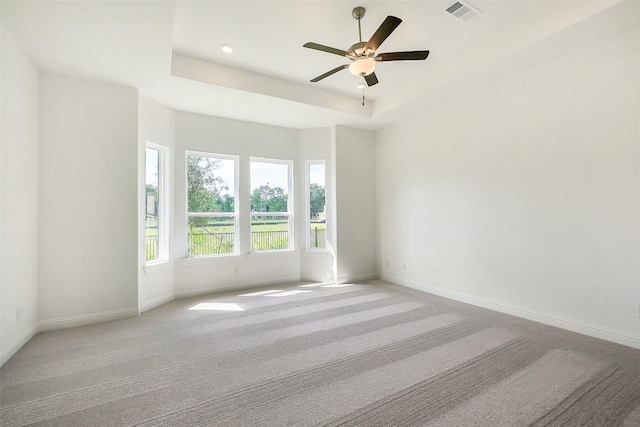 9923 Hunters Run Dr, Missouri City, TX 77459 - spare room with light carpet, a ceiling fan, and a tray ceiling
