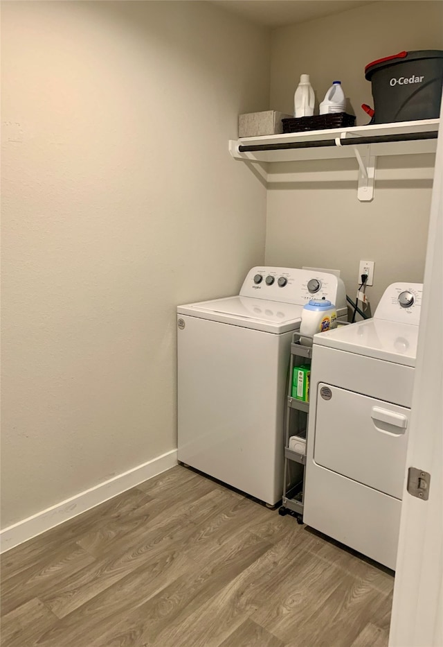 laundry room featuring independent washer and dryer and hardwood / wood-style flooring