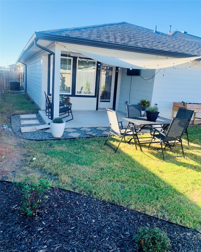 back of house with a patio area and a yard