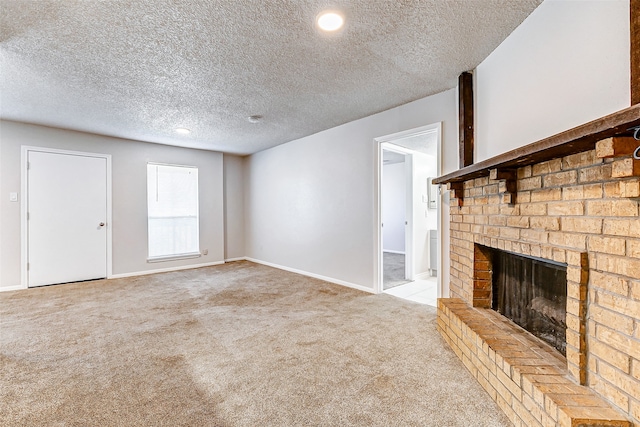 unfurnished living room featuring a textured ceiling, light colored carpet, and a brick fireplace