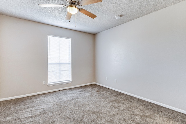 unfurnished room with ceiling fan, carpet, and a textured ceiling