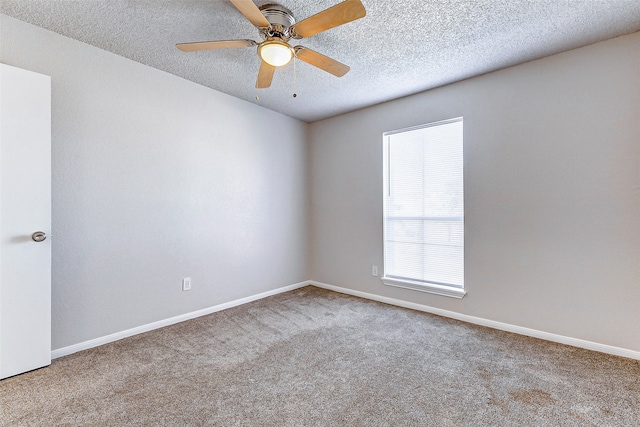 spare room with carpet flooring, a textured ceiling, and ceiling fan