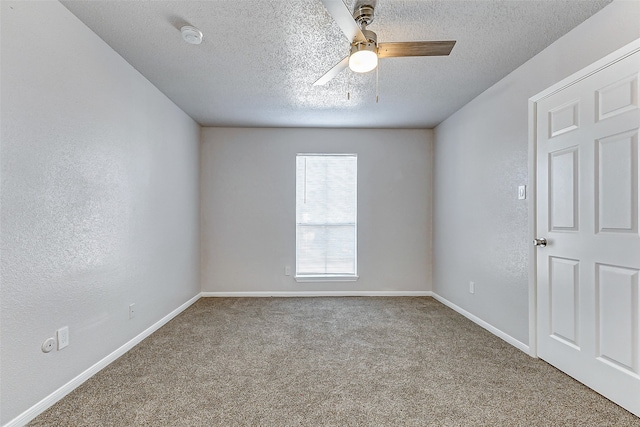 carpeted spare room featuring a textured ceiling and ceiling fan