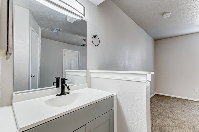 bathroom featuring vanity and a textured ceiling