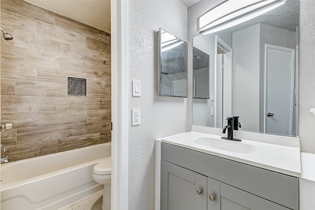 full bathroom with toilet, vanity, a textured ceiling, and tiled shower / bath