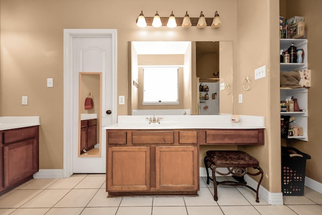 bathroom with tile patterned floors, a shower, and vanity