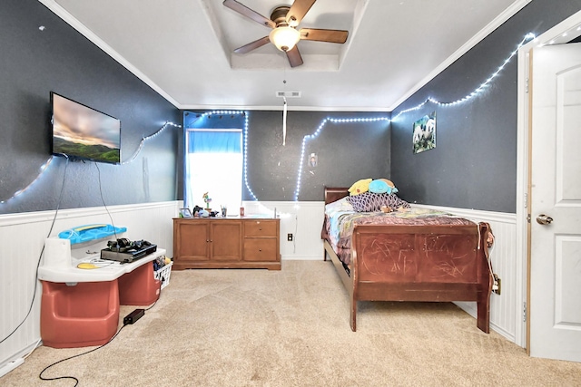 bedroom featuring ceiling fan, ornamental molding, and light carpet