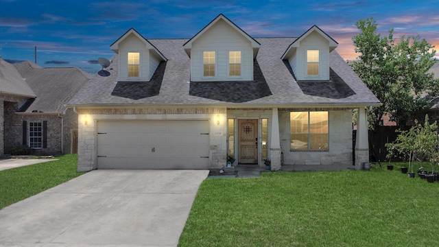 view of front of property featuring a lawn and a garage