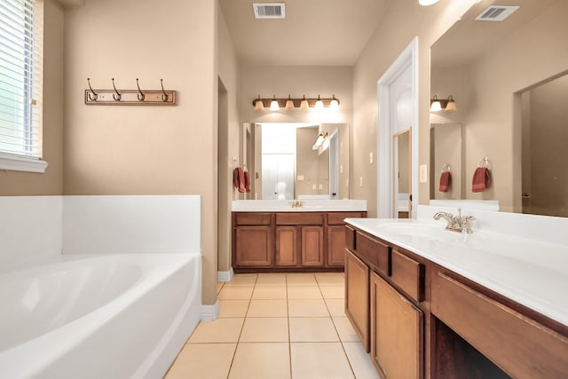 bathroom featuring tile patterned flooring, a washtub, and vanity