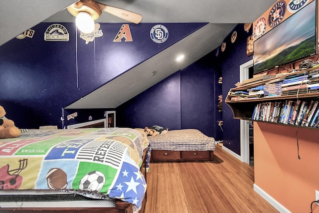 bedroom featuring hardwood / wood-style flooring, ceiling fan, and vaulted ceiling