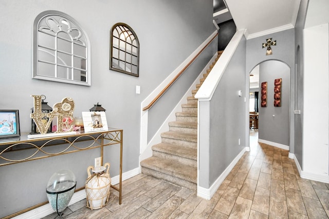 staircase featuring crown molding